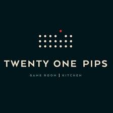 Twenty One Pips logo: a dark background with with words "Twenty One Pips. Game Room, Kitchen." Above the words are three rows of 7 dots on top of each other, however, one dot on the top row is rising above the rest.